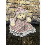Teddy bear in a floral dress and bonnet