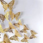 Gold butterfly wall decals on a white background