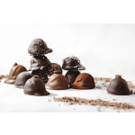 Assorted chocolate truffles on a white surface
