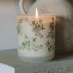 Lit floral-print candle in a glass jar