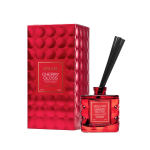 Red reed diffuser bottle with black reeds and matching box