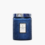 Blue glass candle jar with a patterned lid and label