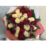 Bouquet of red and cream roses wrapped in pink paper