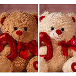 Two plush teddy bears with red bows and heart-shaped pillows