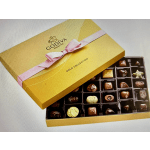Yellow gift box of assorted chocolates with a pink ribbon