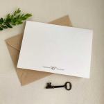 Blank white card on a kraft envelope with a small metal key
