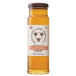 Bottle of orange blossom honey with a labeled cap