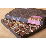 Box of assorted milk chocolates in paper cups