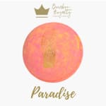 Pink-orange candle with gold accents and the word Paradise