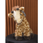 Plush giraffe toy sitting on a dark surface
