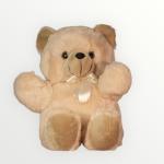 Cream plush teddy bear with a satin bow sitting upright against a light background