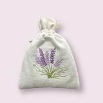Embroidered lavender sprigs on a small drawstring fabric pouch