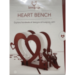 Heart-shaped bench display in red and white with a seated couple silhouette