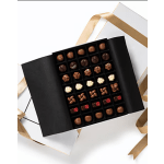 Box of assorted chocolates with a gold ribbon
