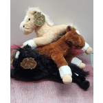 Three plush horse toys stacked on pink mesh fabric