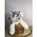 Plush husky toy sitting in a woven basket