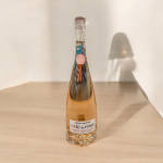Bottle of rosé wine on a wooden table
