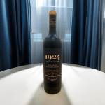 Bottle of red wine standing on a white table