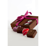 Brown gift box with pink ribbon and assorted chocolates arranged in front on a white surface