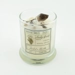 Glass candle jar with a smoky quartz stone on top