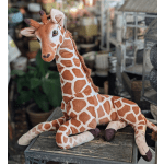 Plush giraffe toy sitting on a wooden surface