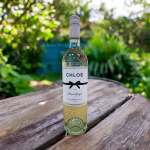 Bottle of Chloe Pinot Grigio on a wooden table outdoors