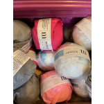 Assorted wrapped yarn skeins in a box