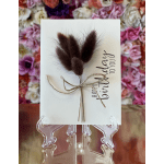 Birthday card with dried bunny tails tied with twine