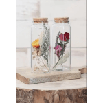 Two glass corked jars with preserved flowers inside