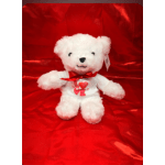 White teddy bear with a red bow and heart "LOVE" shirt on red fabric