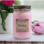 Pink peony-scented candle in a mason jar with flowers in the background