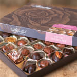 Box of assorted chocolates with a pink label