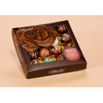 Box of assorted chocolate truffles with decorative drizzles