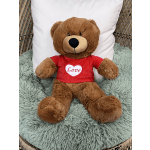 Brown teddy bear in a red shirt with a heart that says Love