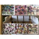 Display rack of colorful floral greeting cards with pressed flower designs