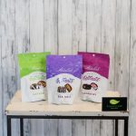 Three bags of chocolate candy on a small table