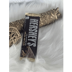 Hershey's chocolate bar wrapped in braided rope decor on white fur
