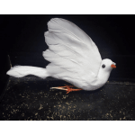 White decorative bird figurine with orange feet on a dark surface