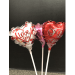 Three heart-shaped "I Love You" balloons on white sticks