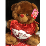 Brown teddy bear holding a red heart that says I Love You