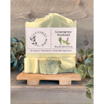 Two bars of lemongrass patchouli soap stacked on a small wooden stand