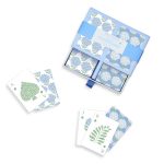 Blue floral playing cards in a box with a few cards spread out