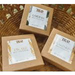 Three boxed body and hand soap bars in a wicker basket.