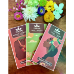 Three chocolate bars with colorful flower accents on a wooden surface