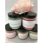 Stacked jars of foaming bath salts topped with a pink silk flower