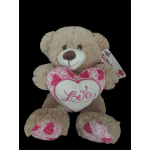 Beige teddy bear holding a pink heart with the word Love
