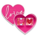 Heart-shaped pink gift boxes with "love" text and small heart cards