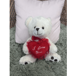 White teddy bear holding a red heart pillow with "I Love You" text