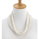 Layered white beaded necklace on a mannequin bust