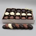 Box of assorted shell-shaped chocolates with a few pieces outside